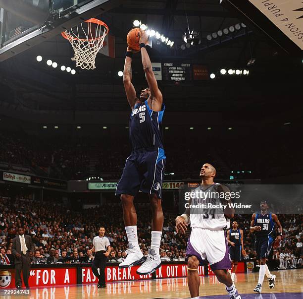 Josh Howard of the Dallas Mavericks takes the ball to the basket past Corliss Williamson of the Sacramento Kings during a game at Arco Arena on...