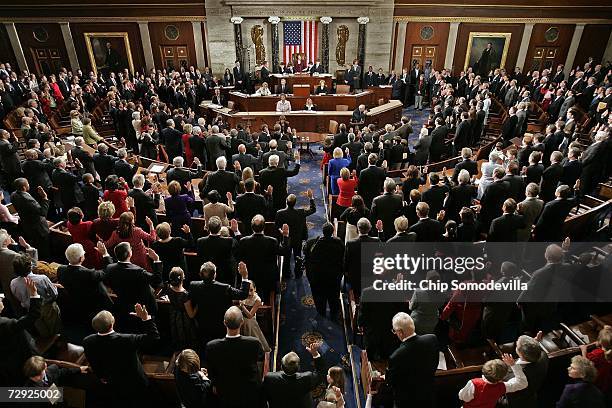 Members of the 110th Congress raise their right hands and take the oath of office during the swearing in ceremony in the House Chamber of the U.S....