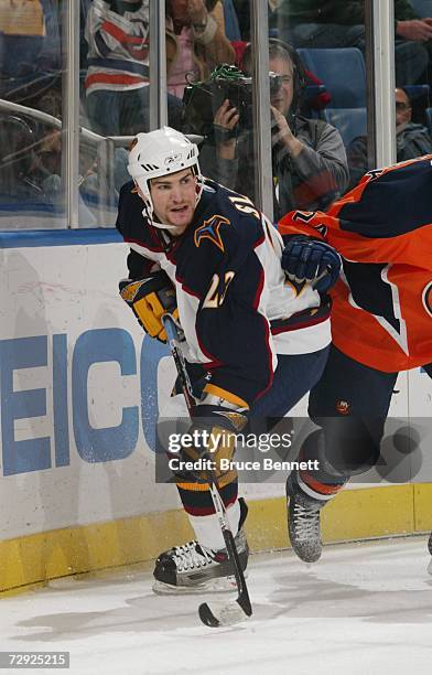 Jim Slater of the Atlanta Thrashers plays the puck during the NHL game against the New York Islanders on December 16, 2006 at the Nassau Coliseum in...