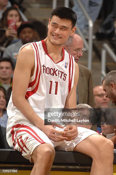 Yao Ming of the Houston Rockets smiles as he waits to enter the game against the Washington Wizards on December 9, 2006 at the Verizon Center in...