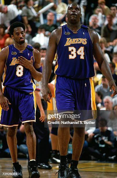 Shaquille O'Neal and Kobe Bryant of the Los Angeles Lakers walk up court against the Indiana Pacers during Game Four of the 2000 NBA Finals on June...