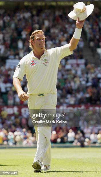 Shane Warne of Australia salutes the crowd as he leaves the field in his last test match on day four of the fifth Ashes Test Match between Australia...