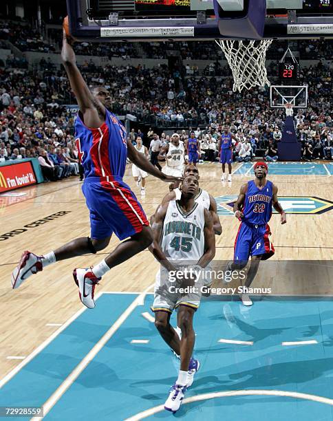 Jason Maxiell of the Detroit Pistons flys in for a dunk in front of Rasual Butler of the New Orleans/Oklahoma City Hornets on January 4, 2007 at the...