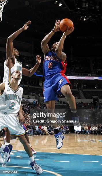 Will Blalock of the Detroit Pistons tries to get a shot off over Jannero Pargo and Cedric Simmons of the New Orleans/Oklahoma City Hornets on January...