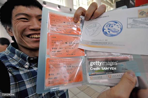 Rail fan displays a souvenir at the Zouying high speed train station in Kaohsiung, 05 January 2007. Taiwan's much-heralded high-speed train took on...