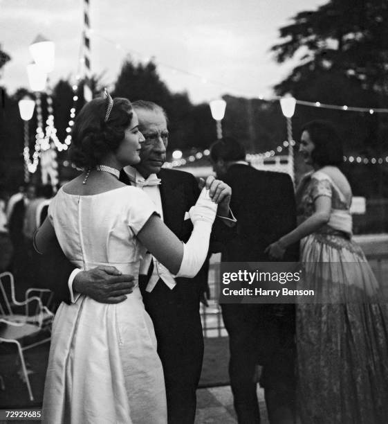 American oil magnate, millionaire and art collector J. Paul Getty dances with his English solicitor, Robina Lund, at a ball held at his home at...