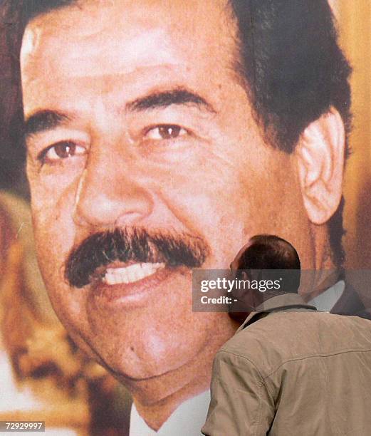 An Iraqi kisses a giant picture of executed president Saddam Hussein, 05 January 2007, in the town of Al-Howeish, north of Baghdad. Egyptian...