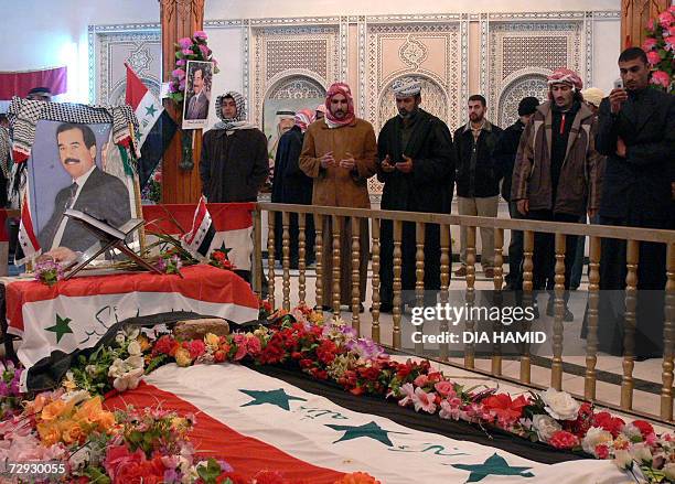 Iraqi Sunni Arabs pray at the grave of hanged dictator Saddam Hussein in his home village of Awja, 05 January 2007. Egyptian President Hosni Mubarak...