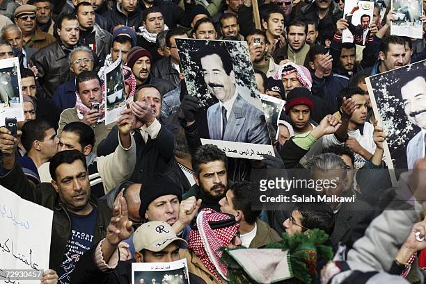 Jordanian demonstrators hold pictures of former Iraqi President Saddam Hussein during a protest against his execution, on January 05, 2007 in Amman,...