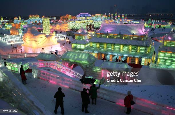 Tourists view ice buildings on display in the Grand Ice and Snow World at 23rd Harbin International Ice and Snow Festival on January 5, 2007 in...