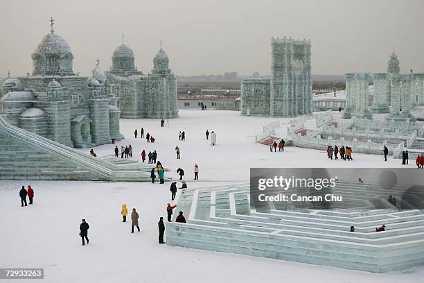 Tourists view ice buildings on display in the Grand Ice and Snow World at 23rd Harbin International Ice and Snow Festival on January 5, 2007 in...