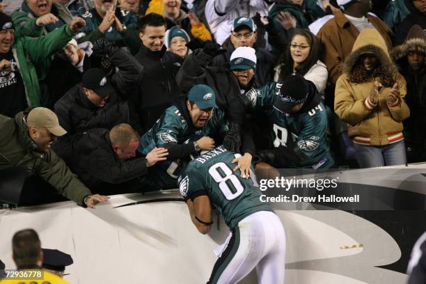 Wide receiver Hank Baskett of the Philadelphia Eagles jumps into the crowd after a touchdown during the game against the Atlanta Falcons on December...