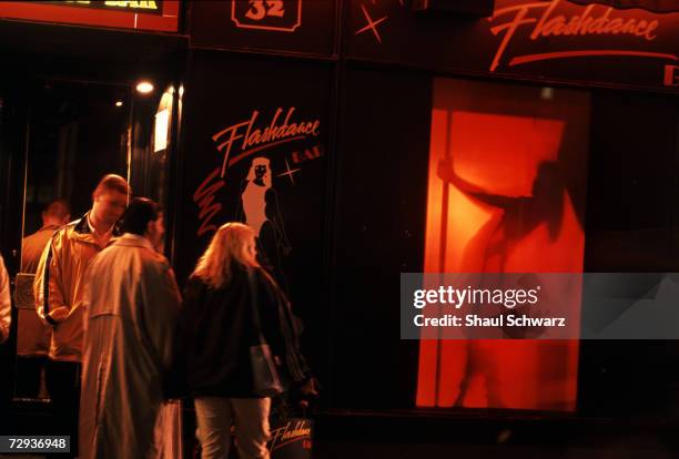 Men stand outside a strip club in Budapest, Hungary.