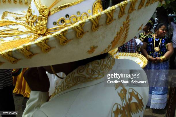 Man wears a sombrerro at the Regada Ceremony in Juchitan, Mexico, June 5, 2003. Whether it is a religious ceremony or an Indian celebration, every...
