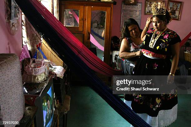 Twenty-two year old queen Nidia Lopez Lagunas is being helped by her mom as she gets ready to go out for the final party in Juchitan, Mexico, June 6,...