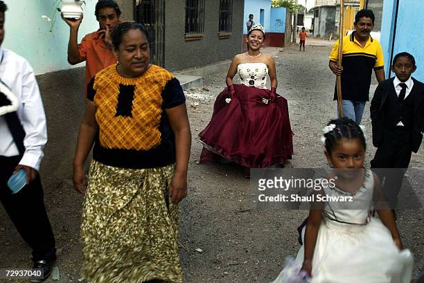 Twenty-three year old queen Lizbeth Cruz Antonio on her way home after the regada celebration, June 5, 2003. Whether it is a religious ceremony or an...