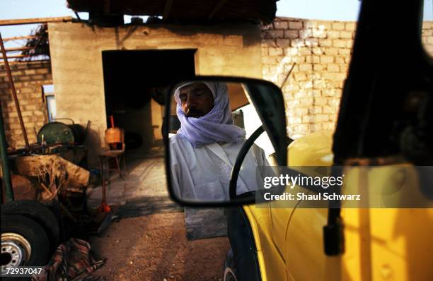 Palestinian bedoin man looks in his car mirror in the Sinai Desert in Egypt. Bedouins are Arab nomadic pastoralist groups, primarily found in the...