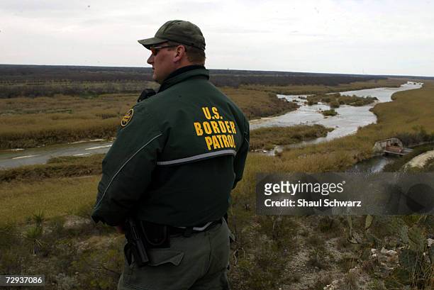 Eagle Pass Border Patrol look over the Rio Grande scanning the area illegal traffic, February 06, 2003. Hundreds of illegal immigrants attempt to...