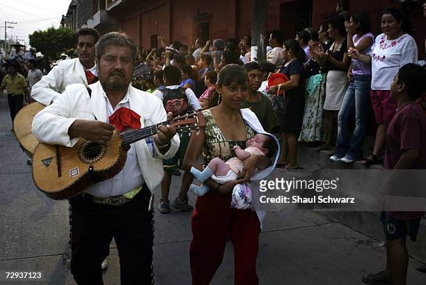 Mexicans enjoy the parade for the Regada Ceremony in Juchitan, Mexico, June 5, 2003. Whether it is a religious ceremony or an Indian celebration,...