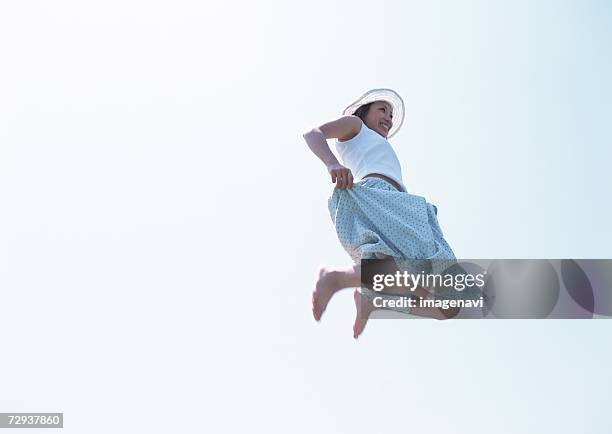 woman jumping up in field - japanese women feet stock pictures, royalty-free photos & images