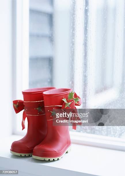 red gum-boot on windowsill - nikolausstiefel stock-fotos und bilder