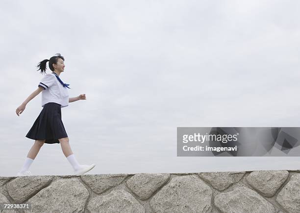 teenage girl walking on pier - japan 12 years girl stock pictures, royalty-free photos & images