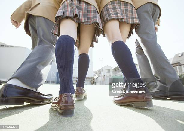 rear view of teenagers at starting line - japanese short skirts stockfoto's en -beelden