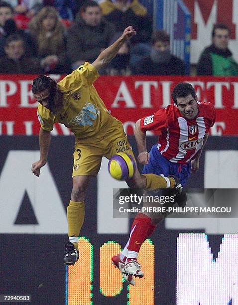 Atletico de Madrid's Spanish defender Pablo Ibanez Tebar vies with Gimnastic de Tarragona's Spanish defender Mingo during their Liga football match...