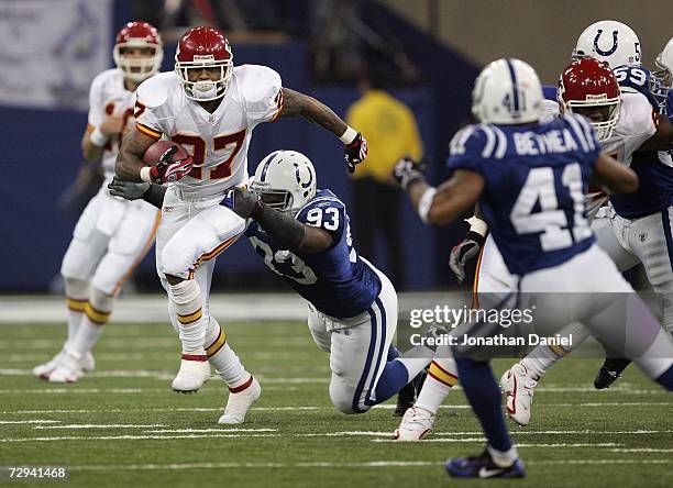 Larry Johnson of the Kansas City Chiefs runs the ball against Dwight Freeney of the Indianapolis Colts during their AFC Wild Card Playoff Game...