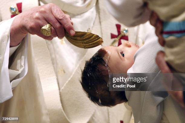 Pope Benedict XVI celebrates the baptism of thirteen children at the world famous Sistine Chapel on January 7, 2006 in Vatican City.