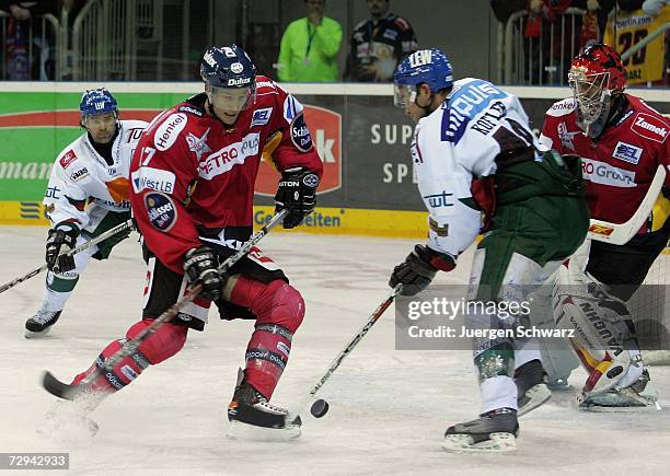 Charlie Stephens of Duesseldorf and Augsburg's Manuel Kofler fight for the puck during the DEL Bundesliga match between DEG Metro Stars and...