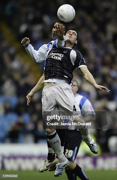 Stephan Jordan of Manchester City jumps with Marcus Tudgay of Sheffield Wednesday during the FA Cup sponsored by E.ON Third Round match between...