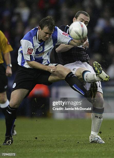 Richard Dunne of Manchester City battles with Glenn Whelan of Sheffield Wednesday during the FA Cup sponsored by E.ON Third Round match between...