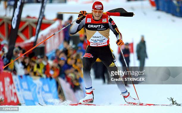 Germany's Tobias Angerer celebrates after winning the inaugural six-leg Tour de Ski after the men's World Cup cross-country 11 km free final climb...