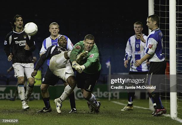 Mark Crossley of Sheffield Wednesday saves at the feet of Darius Vassell of Manchester City, during the FA Cup sponsored by E.ON Third Round match...