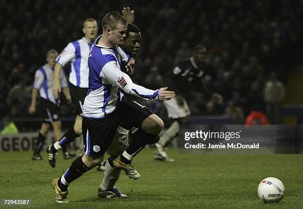 Nedum Onoha of Manchester City battles with Chris Brunt of Sheffield Wednesday during the FA Cup sponsored by E.ON Third Round match between...