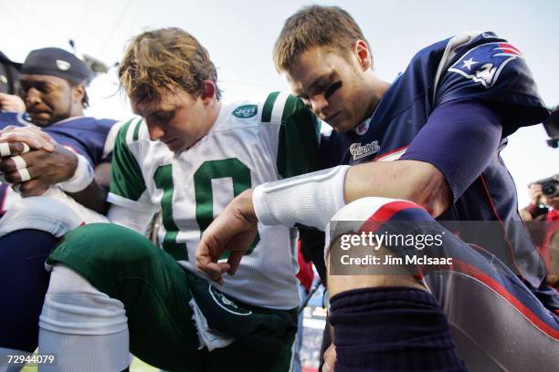 Chad Pennington of the New York Jets and Tom Brady of the New England Patriots hang their heads in prayer after their AFC Wild Card Playoff Game at...