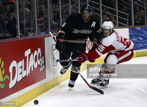 Teemu Selanne of the Anaheim Ducks chases after a puck as he bumps into Niklas Kronwall of the Detroit Red Wings during the game at the Honda Center...