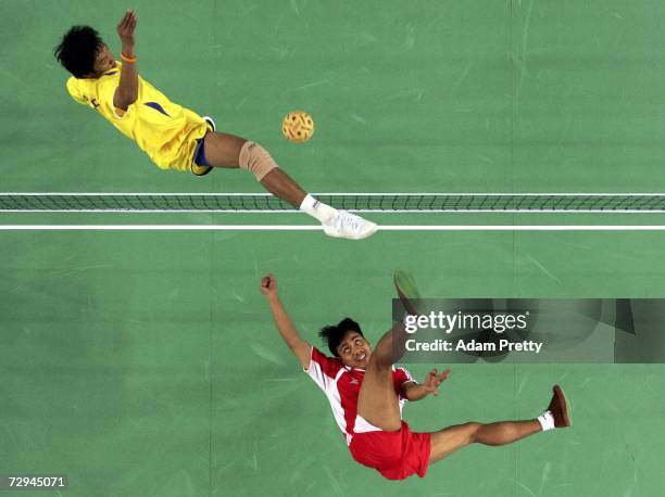 Jusri Pakke of Indonesia spikes the ball past Purich Pansira of Thailand during the Sepaktakraw Men's Double Competition during the 15th Asian Games...