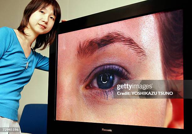 Misa Nakayama of Japan's electronics giant Matsushita, unveils the prototype model of a 42-inch sized high-definition plasma display panel , which...