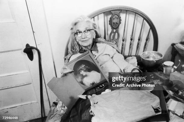 Edith 'Big Edie' Bouvier Beale , whose niece was Jacqueline Kennedy Onassis, with a portrait of her younger self at home in Grey Gardens, a run-down...