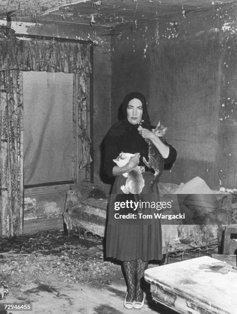 Edith Bouvier Beale , a cousin of Jacqueline Kennedy Onassis, at home with her cats in Grey Gardens, a run-down mansion in East Hampton, New York,...