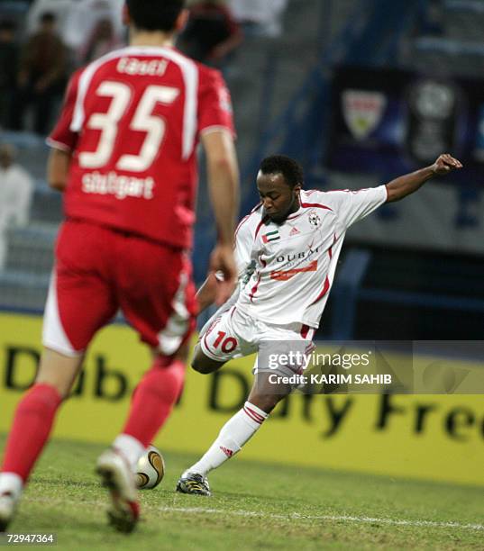 Dubai, UNITED ARAB EMIRATES: Stuttgart's defender Serdar Tasci tries to block United Arab Emirates national team player Ismail Matar from scoring a...