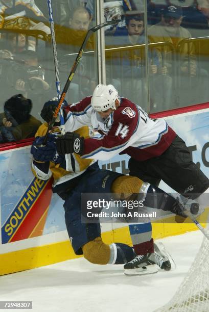 Ian Laperriere of the Colorado Avalanche checks Shea Weber of the Nashville Predators at Gaylord Entertainment Center on January 1, 2007 in...