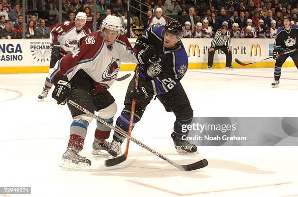 Marty Murray of the Los Angeles Kings battles against John-Michael Liles of the Colorado Avalanche at Staples Center on December 9, 2006 in Los...