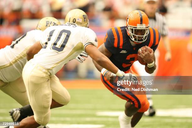 Running back Delone Carter of the Syracuse Orange runs against Mike Phillips of the University of Pittsburgh Panthers at the Carrier Dome on October...