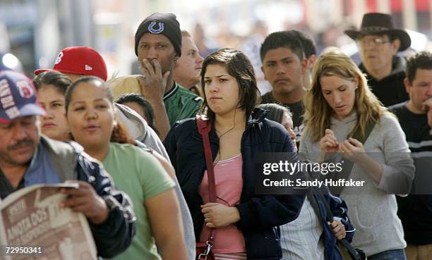 Pedestrians wait in line to enter the United States at the border in Tijuana Mexico from the United States January 8, 2007 in San Ysidro, California....