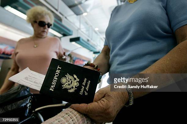 Travelers take out their passports before checking in at San Diego International Airport January 8, 2006 in San Diego, California. Beginning on...