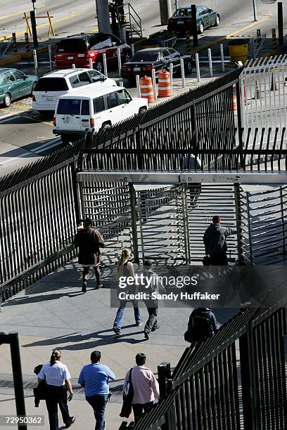 Pedestrians head through turnstiles into Mexico from the United States on Monday, January 8, 2006 in San Ysidro, California. Beginning on January...