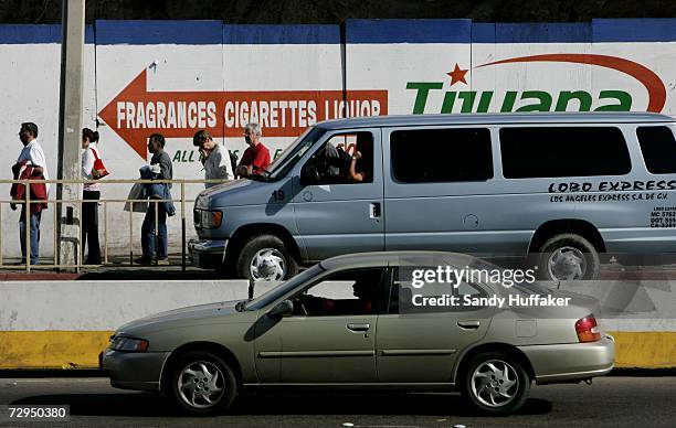 Pedestrians and motorist wait in line to enter the United States at the border in Tijuana Mexico from the United States January 8, 2007 in San...